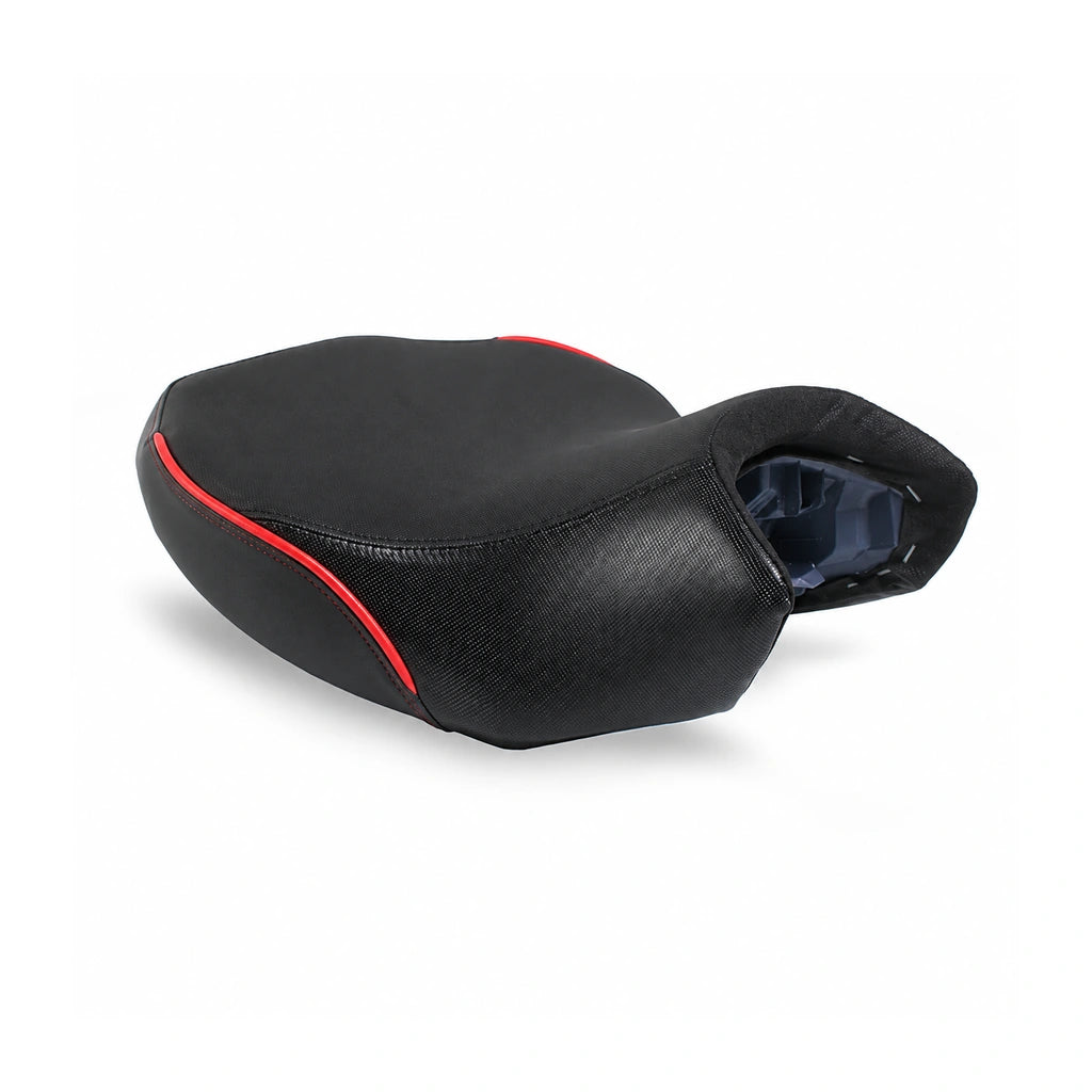 Black touring motorcycle seat viewed obliquely from above, with a broad contoured seating surface, textured sides and red piping, on white.